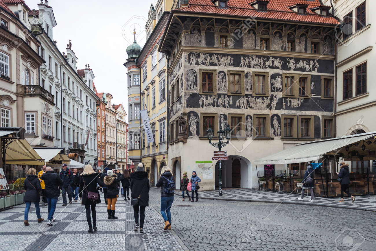 Prague, Czech Republic- November 12, 2017: People Are Passing By The House  Of The Minute While Visiting Old Town Of Prague. This Building Is A Typical  Example Of Czech Renaissance Townhouse Architecture.