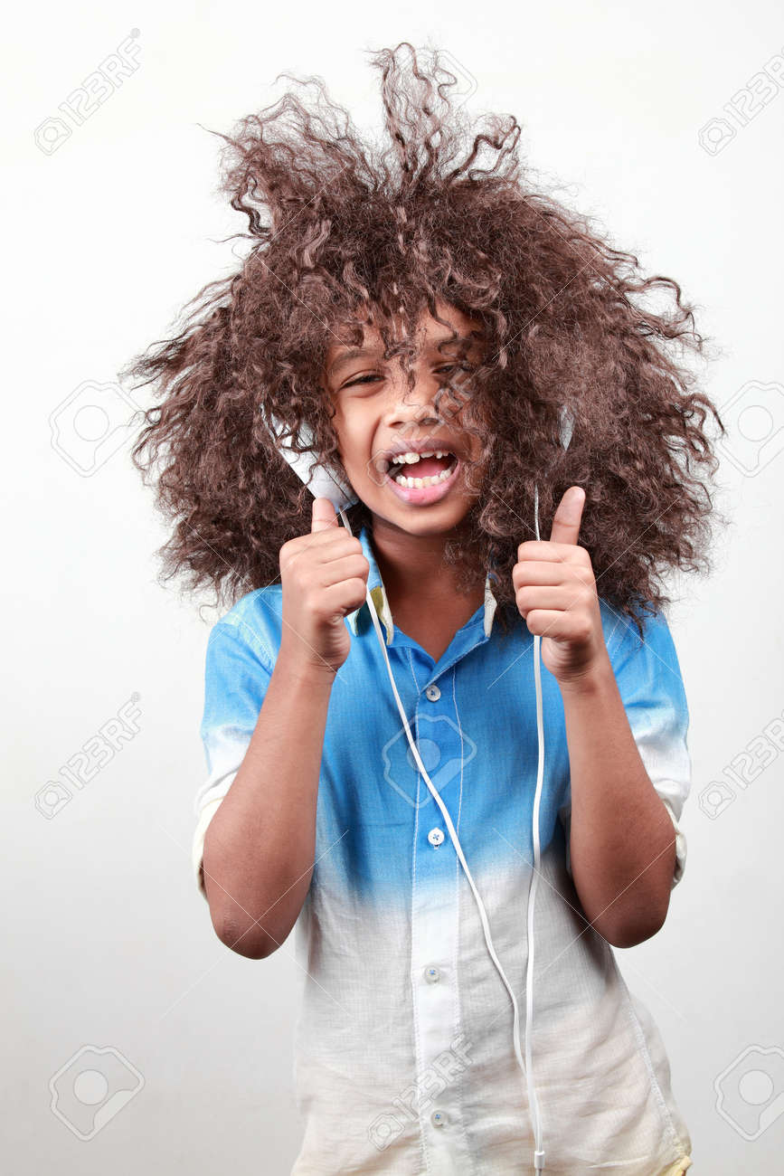 A Boy With A Funky Hairstyle In A Playful Mood