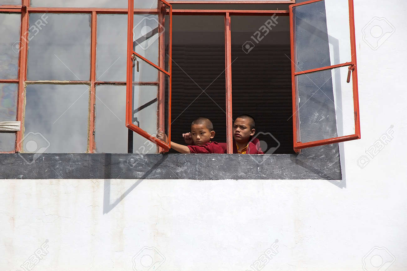 Young Monks In Traditional Robes At The Window At The Dali Monastery
