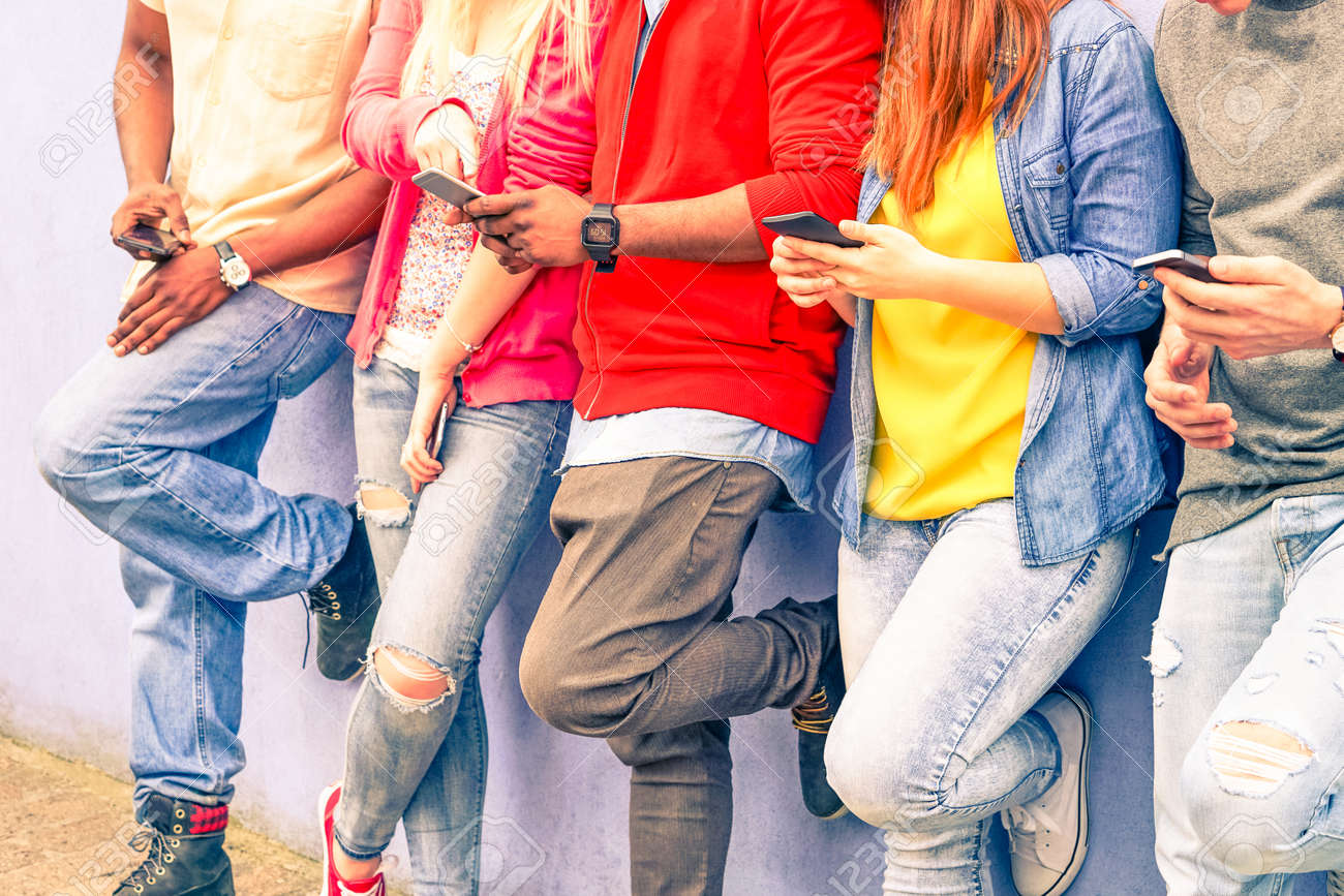 Multiracial group of friends texting sms and looking down to cell phone - Interracial students hands using mobile - Concept of young people addiction to web technology - Focus on hand of red hair girl - 55465884 Multiracial group of friends texting sms and looking down to cell phone - Interracial students hands using mobile - Concept of young people addiction to web technology - Focus on hand of red hair girl - 55465884