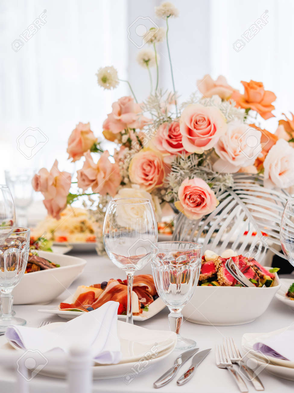 Table Served For Wedding Banquet With Cutlery And Flowers In