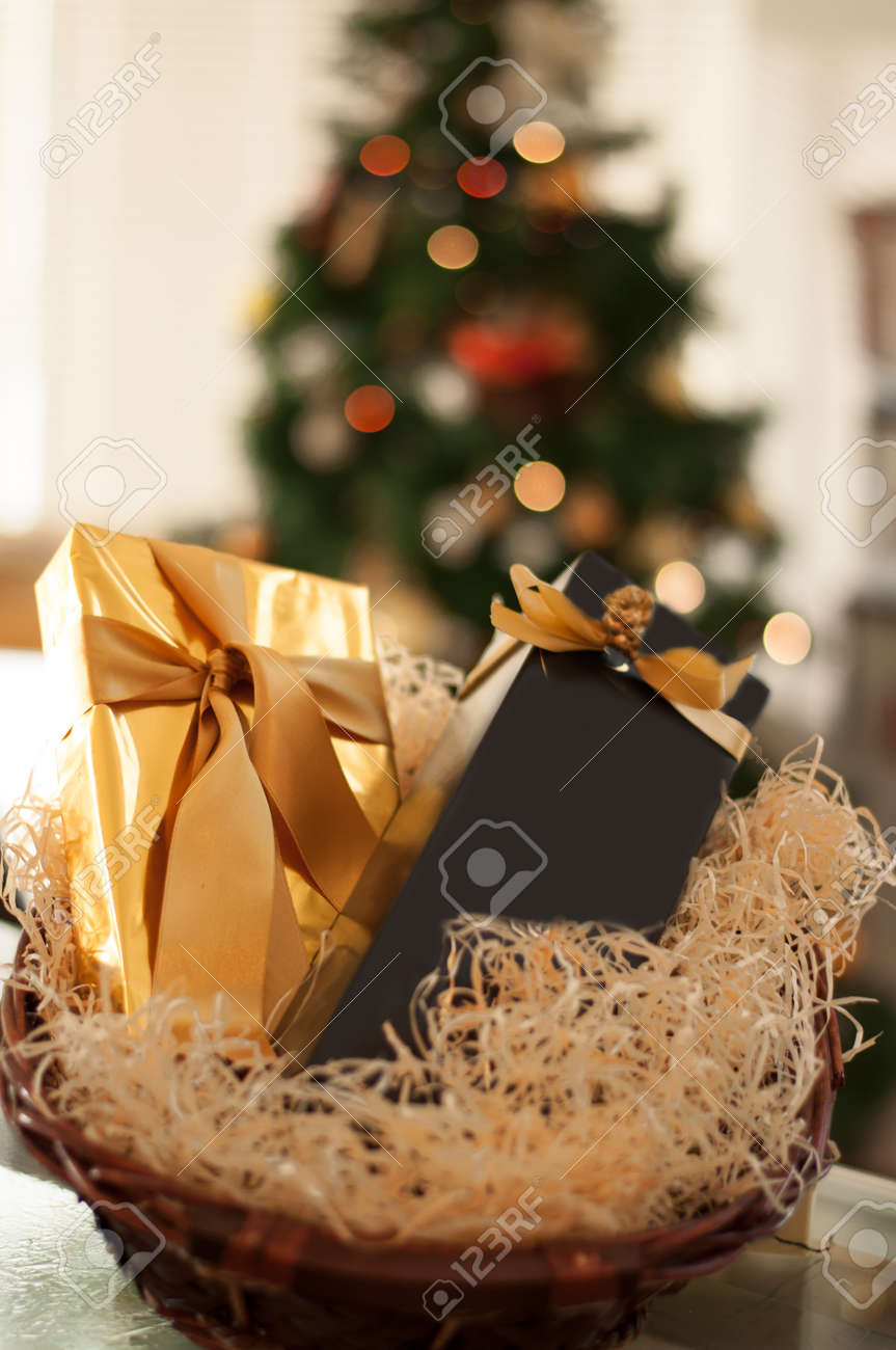 Decorative New Year's Gift Baskets With A Set Of Sweets And Alcohol On A  Wooden Table On A Christmas Tree Background Stock Photo, Picture And  Royalty Free Image. Image 96395422.