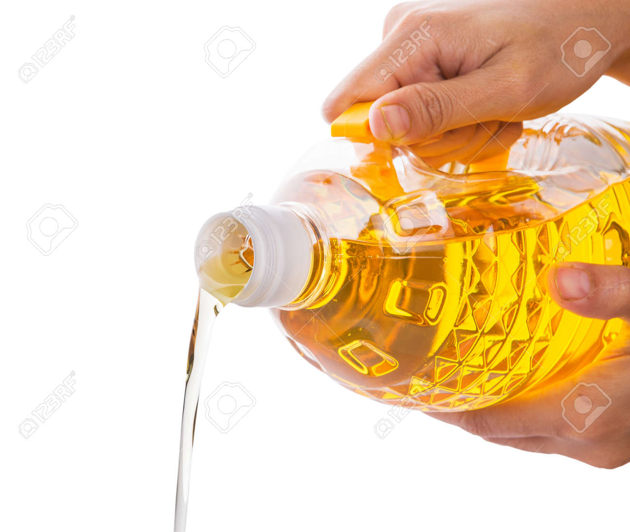 Female Hand Pouring A Vegetable Cooking Oil From A Plastic Container Over  White Stock Photo, Picture and Royalty Free Image. Image 25030115., image size:1300x1098