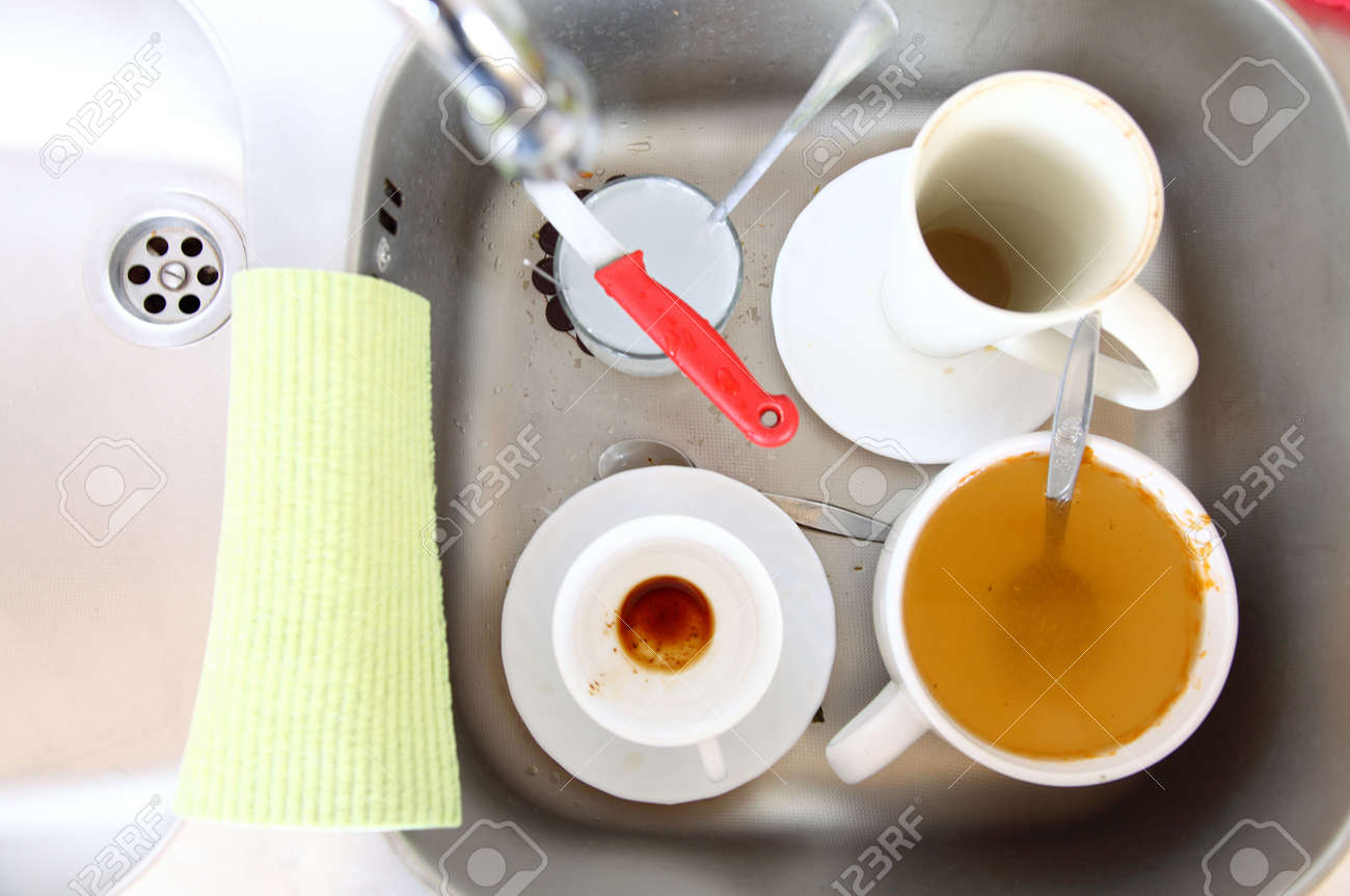 Kitchen Sink With Dishes washing up. white dirty dishes in the kitchen sink. stock photo Kitchen Sink With Dishes washing up. white dirty dishes in the kitchen sink. stock photo