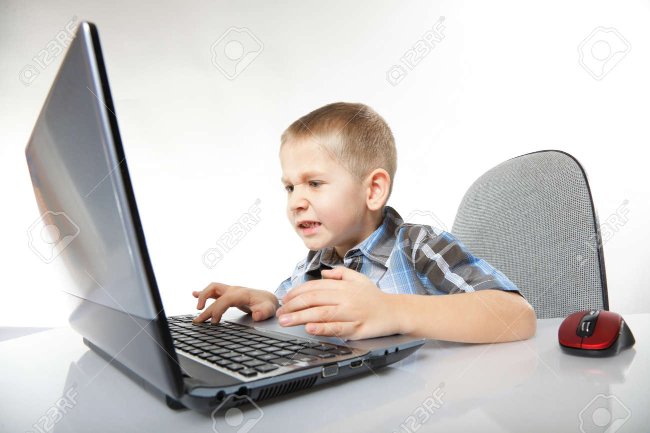 computer addiction emotional child boy with laptop notebook playing computer addiction