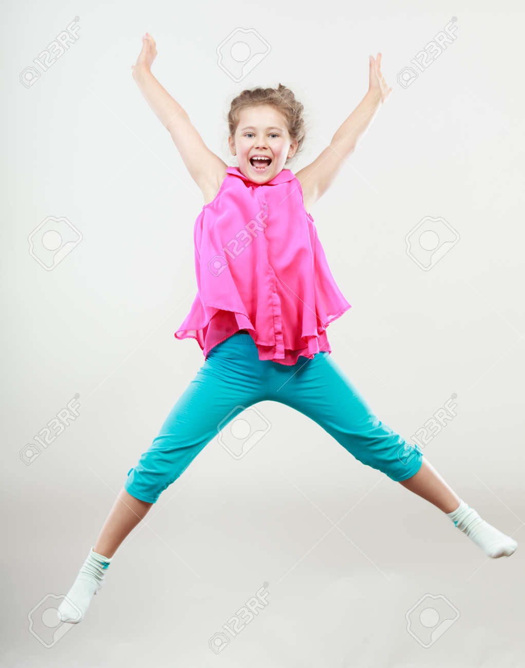excited happy little girl jumping for joy in air joyful cheerful