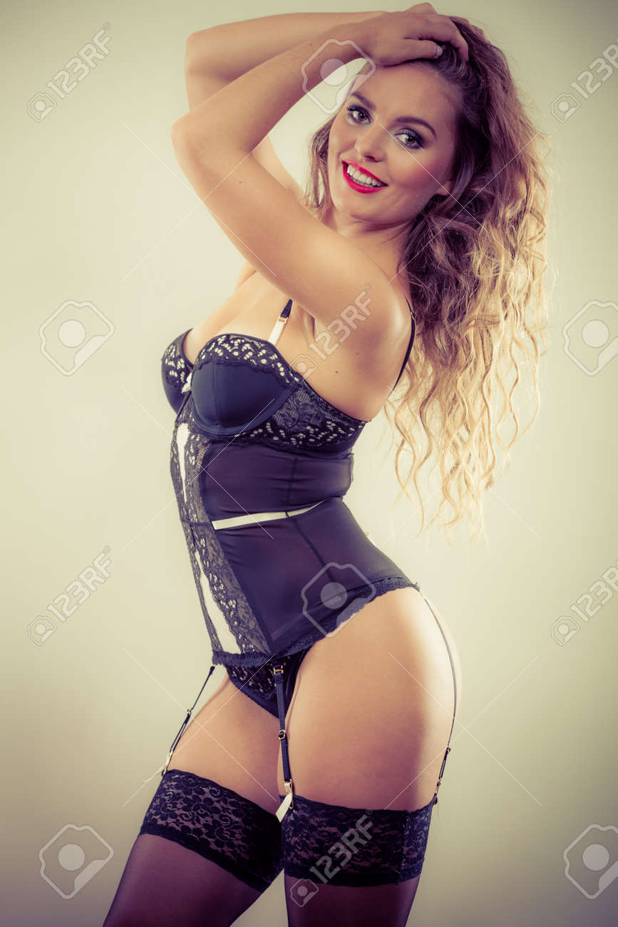 Erotic And Provocative. Sensual Attractive Long Haired Female Model Posing  In Black Sexy Lingerie In Studio. Stock Photo, Picture and Royalty Free  Image. Image 48558875.