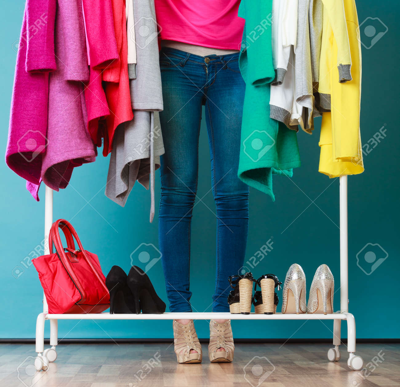 Closeup of woman choosing clothes to wear in wardrobe. Girl customer shopping in mall shop. Fashion clothing sale concept. - 54558848 Closeup of woman choosing clothes to wear in wardrobe. Girl customer shopping in mall shop. Fashion clothing sale concept. - 54558848