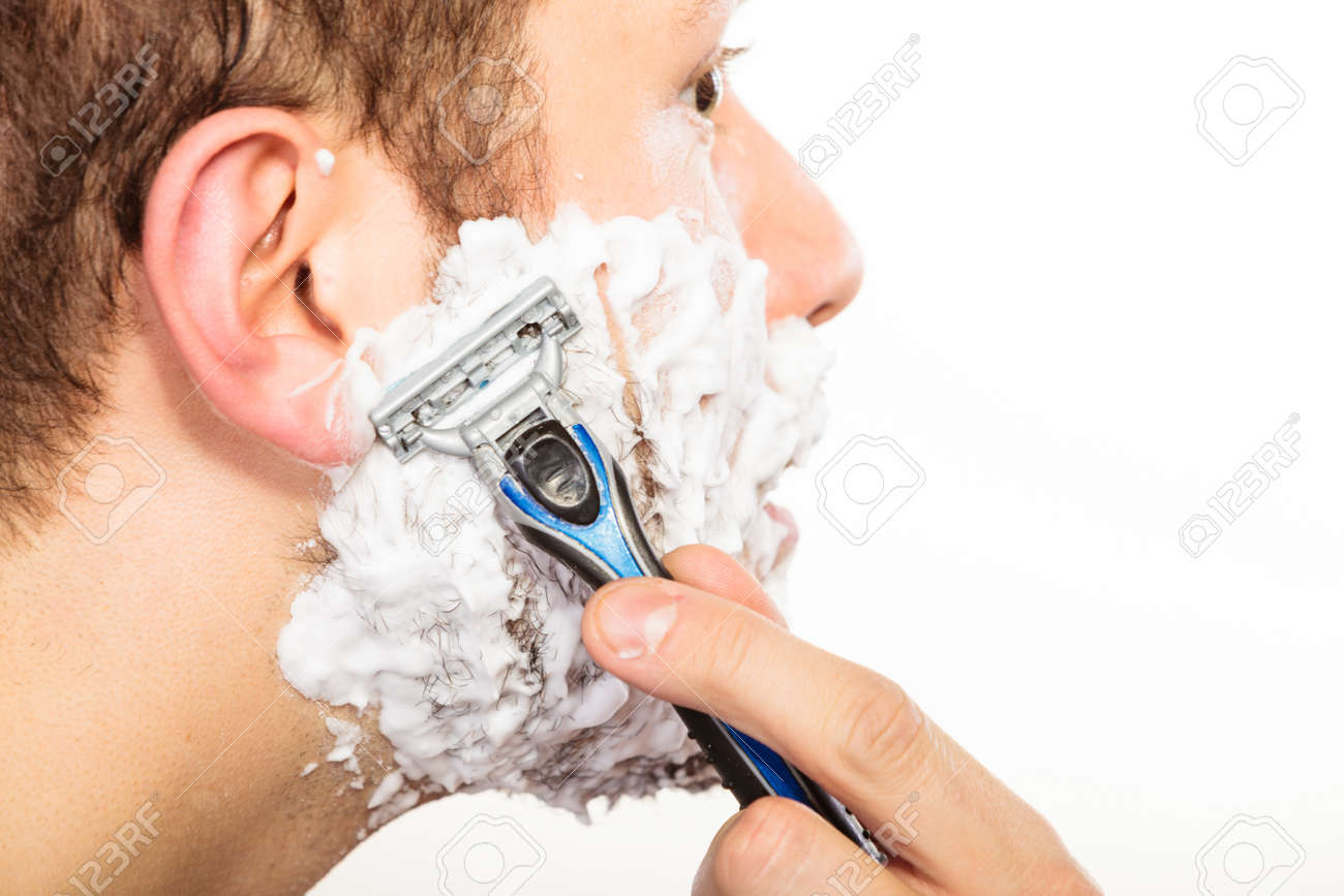 man shaving using razor with cream foam guy removing face beard