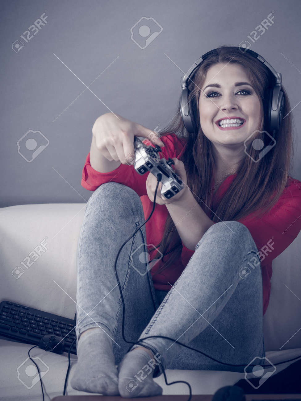 Nerd Geek Young Adult Women Playing On The Video Console Holding Game Pad Sitting On Sofa Nerd Geek Young Adult Women Playing On The Video Console Holding Game Pad Sitting On Sofa