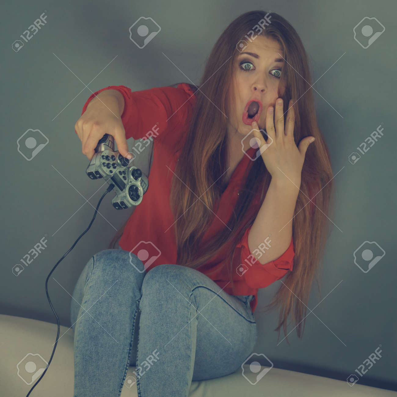 Nerd Geek Shocked Adult Women Playing On The Video Console Holding Game Pad Sitting On Sofa Nerd Geek Shocked Adult Women Playing On The Video Console Holding Game Pad Sitting On Sofa
