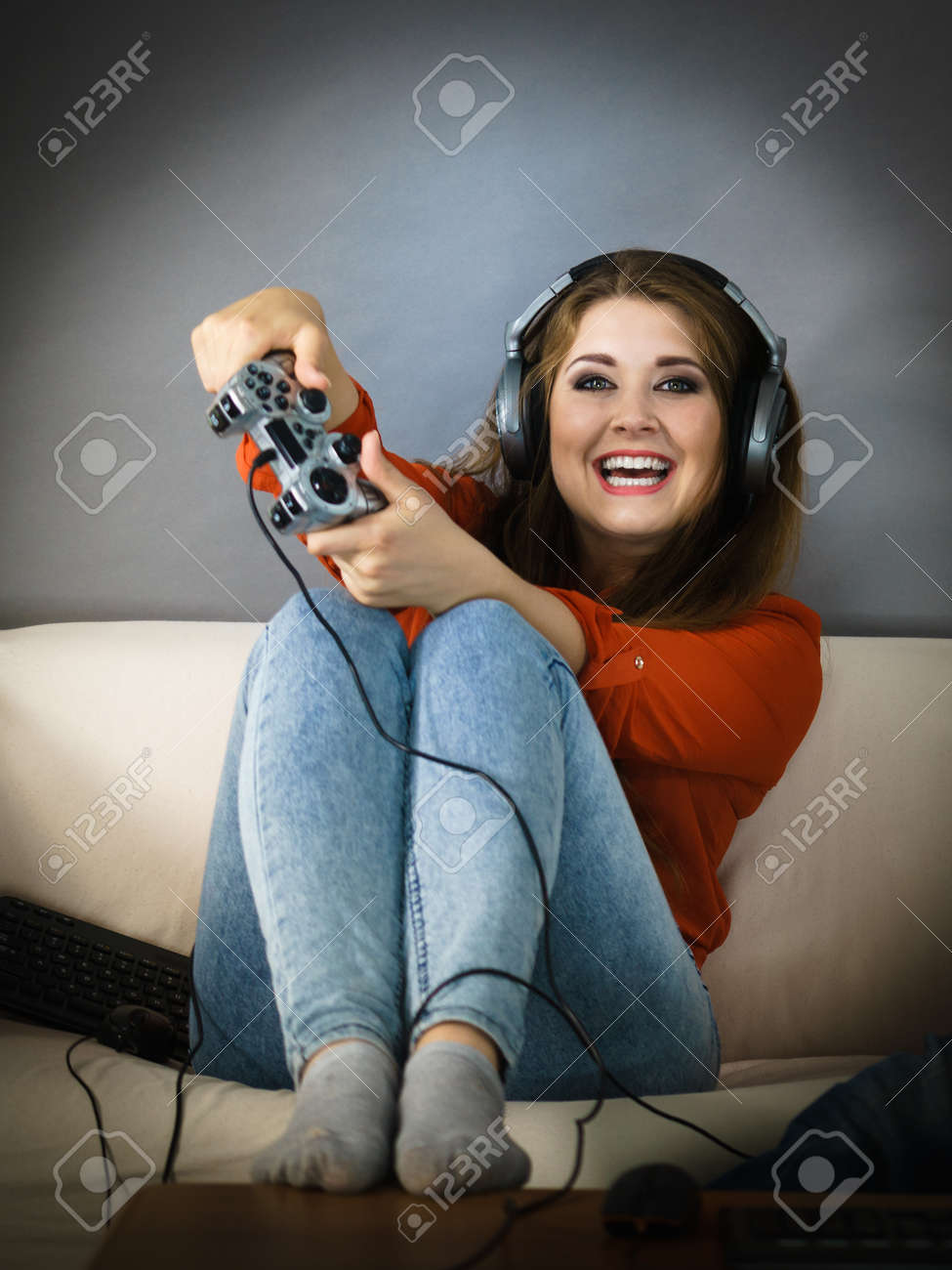 Nerd Geek Young Adult Women Playing On The Video Console Holding Game Pad Sitting On Sofa Nerd Geek Young Adult Women Playing On The Video Console Holding Game Pad Sitting On Sofa