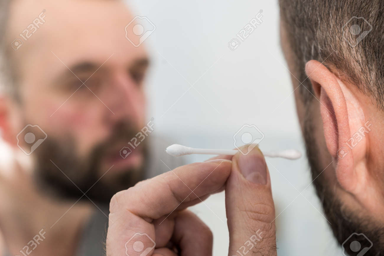 Man About To Clean His Ears Using Q Tip Cotton Swab Hygiene