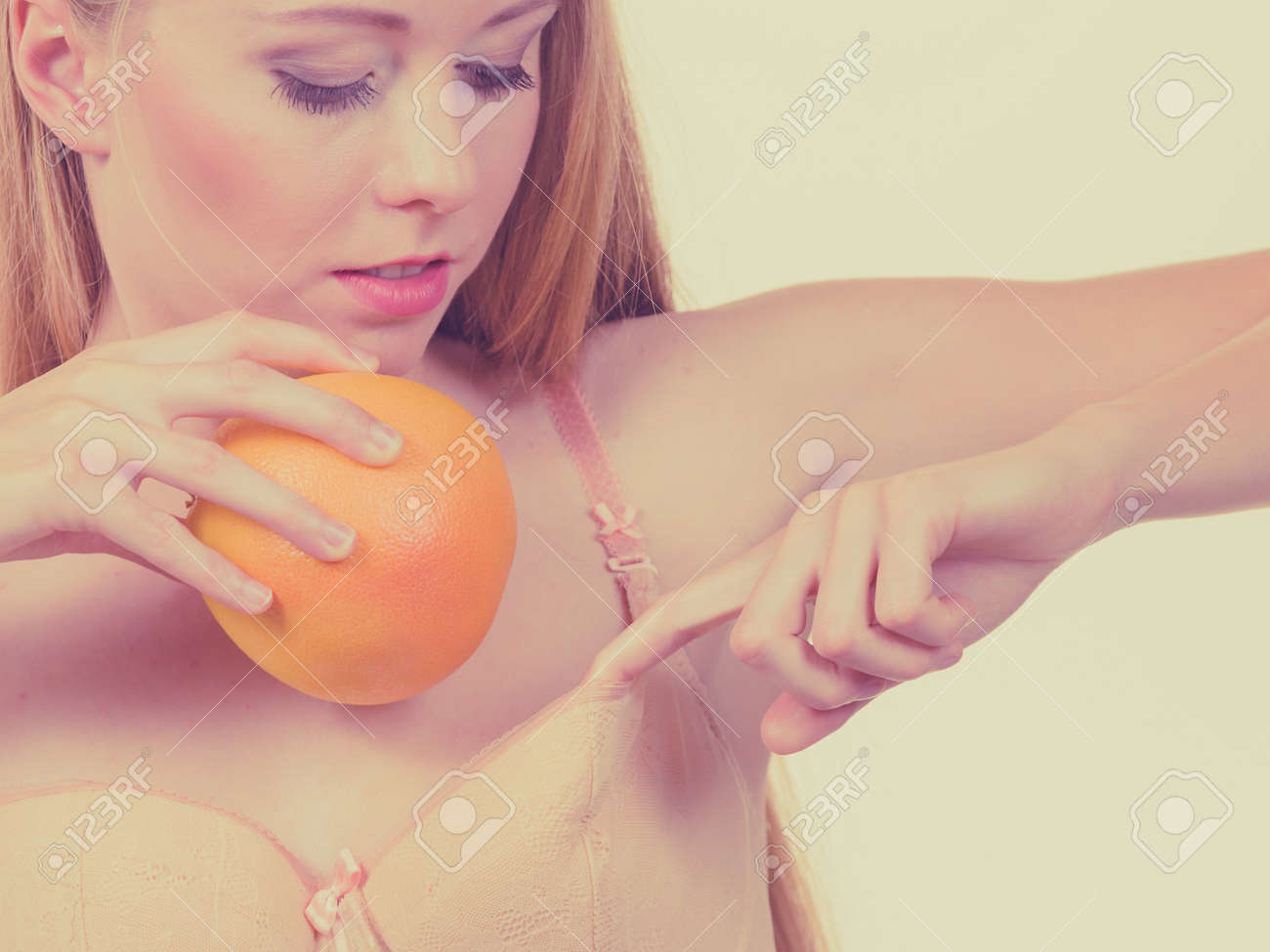 Slim Young Woman Small Boobs Puts Big Orange Fruit In Her Bra