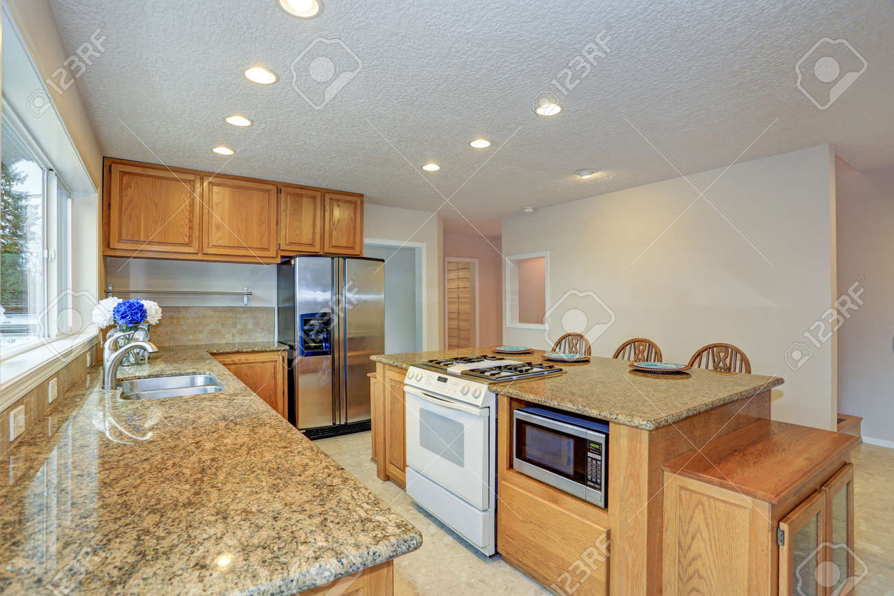 Remodeled Natural Light Kitchen With Wooden Kitchen Cabinets