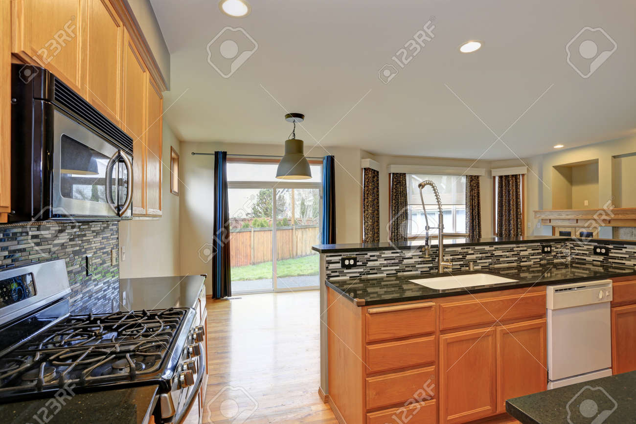 Small Compact Kitchen Room With Light Wood Cabinetry Quartz