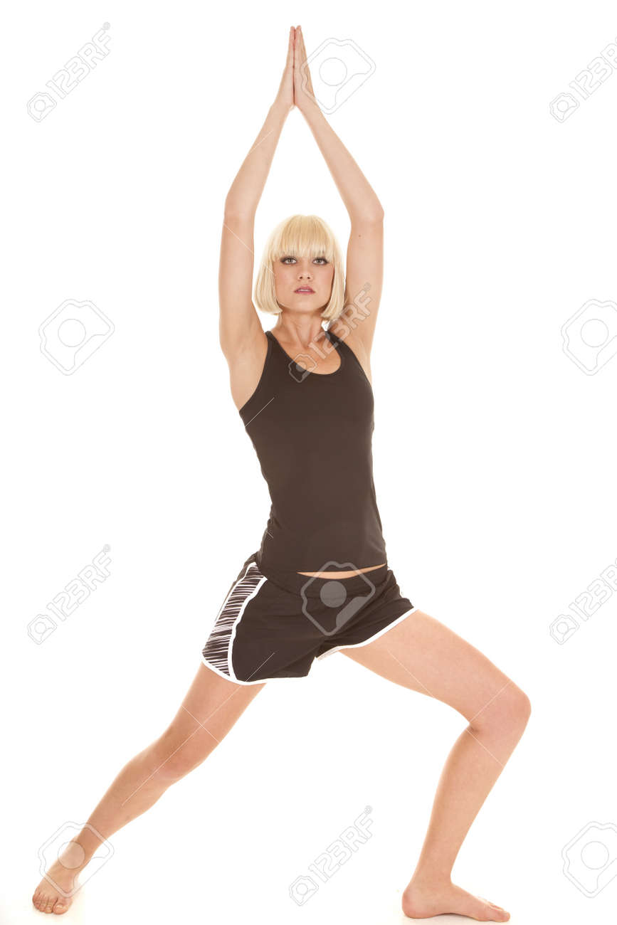 A Woman Reaching Up To The Sky In A Yoga Pose Stock Photo
