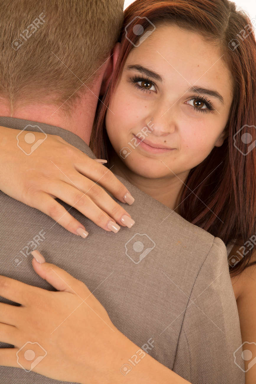A Woman With Her Arms Wrapped Around Her Mans, Looking Over His Shoulder.  Фотография, картинки, изображения и сток-фотография без роялти. Image  51752446