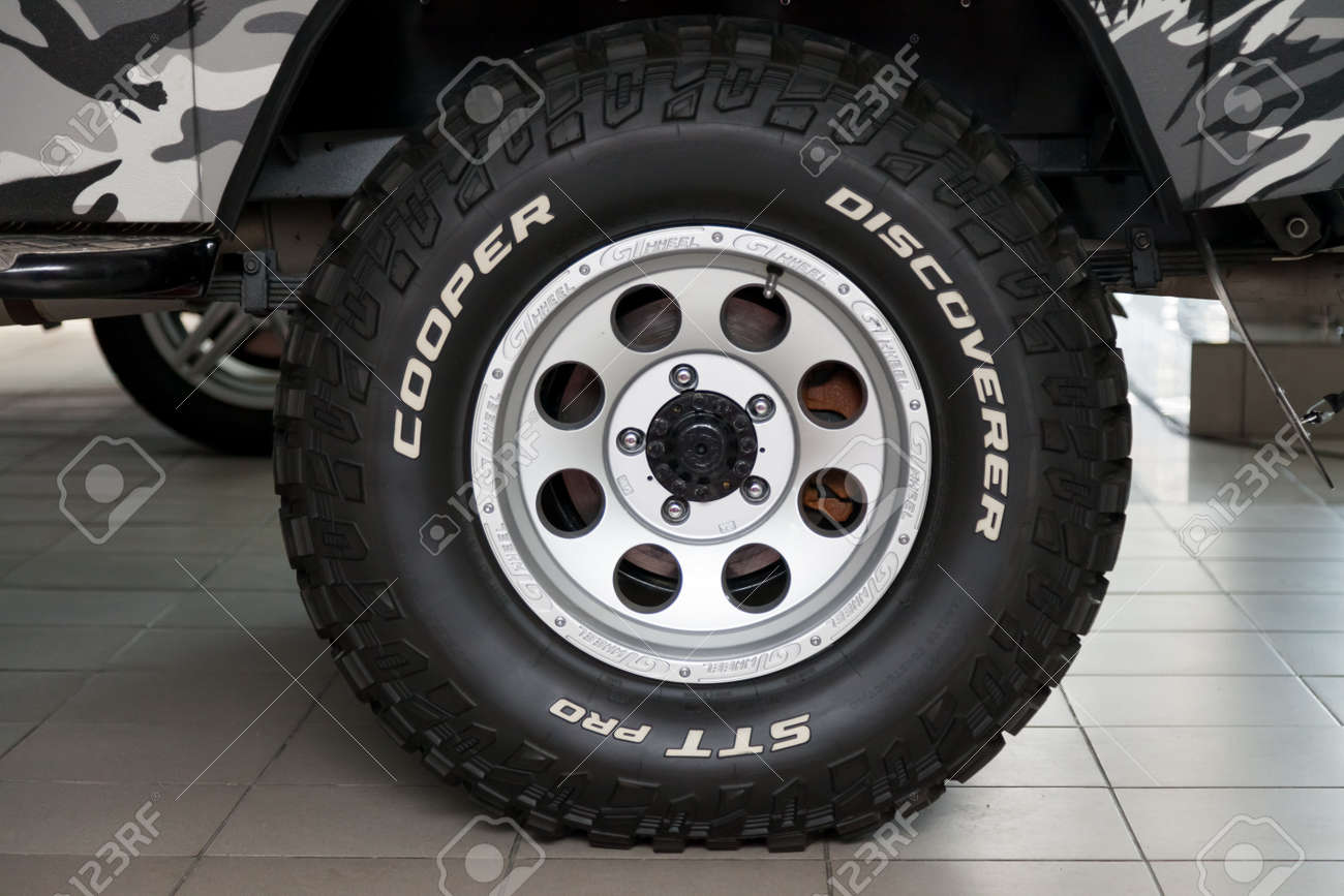 Novosibirsk, Russia - 02.26.2020: The most extreme all-season, off-road tire Cooper Discoverer STT Pro with off-road performance, tread design, tire durability on the wheel disk. - 141315394 Novosibirsk, Russia - 02.26.2020: The most extreme all-season, off-road tire Cooper Discoverer STT Pro with off-road performance, tread design, tire durability on the wheel disk. - 141315394