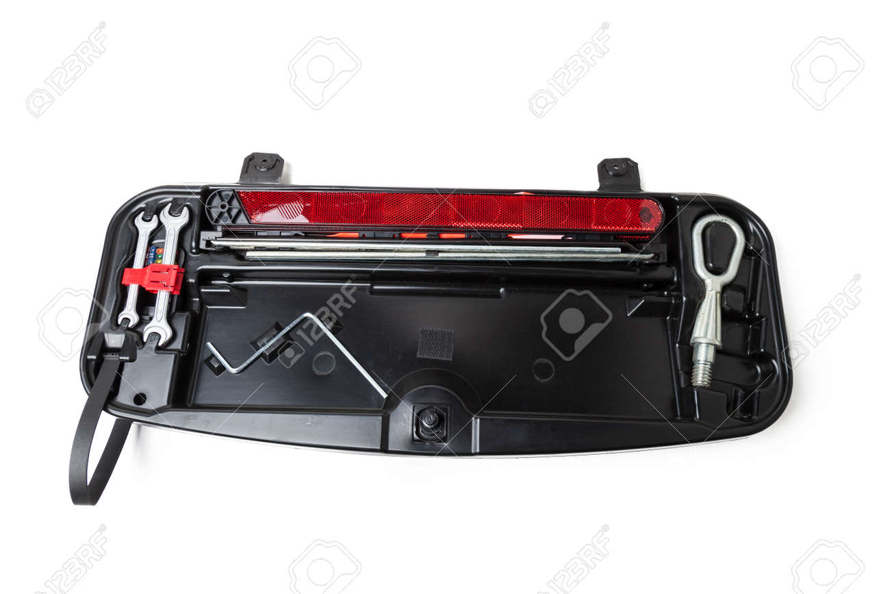 warning triangle, wrench and transportation hook on a black cover for car repair on the road in the absence of insurance on a white isolated background. Spare parts catalog - 168997412 warning triangle, wrench and transportation hook on a black cover for car repair on the road in the absence of insurance on a white isolated background. Spare parts catalog - 168997412