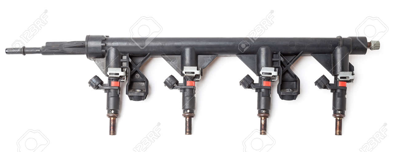 Close-up on a car fuel rail with injectors for supplying gasoline to a four cylinder engine on a white isolated background. Spare parts catalog. - 169051381 Close-up on a car fuel rail with injectors for supplying gasoline to a four cylinder engine on a white isolated background. Spare parts catalog. - 169051381