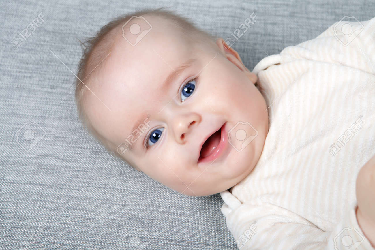Head shoot of cute baby with blue eyes and nice smile stock photo 11742696