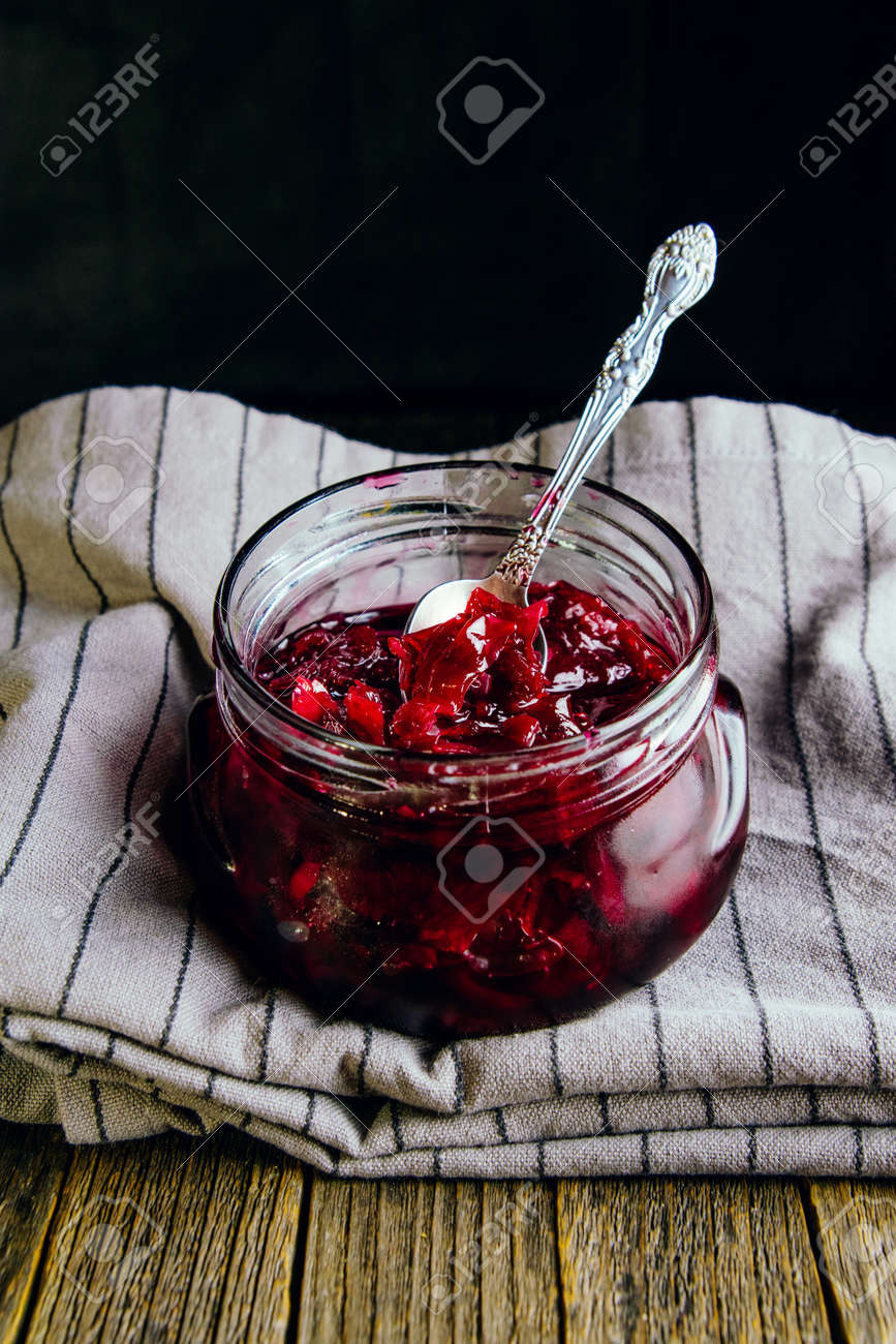 Homemade jam from rose petals in a jar on a dark background - 152811658 Homemade jam from rose petals in a jar on a dark background - 152811658