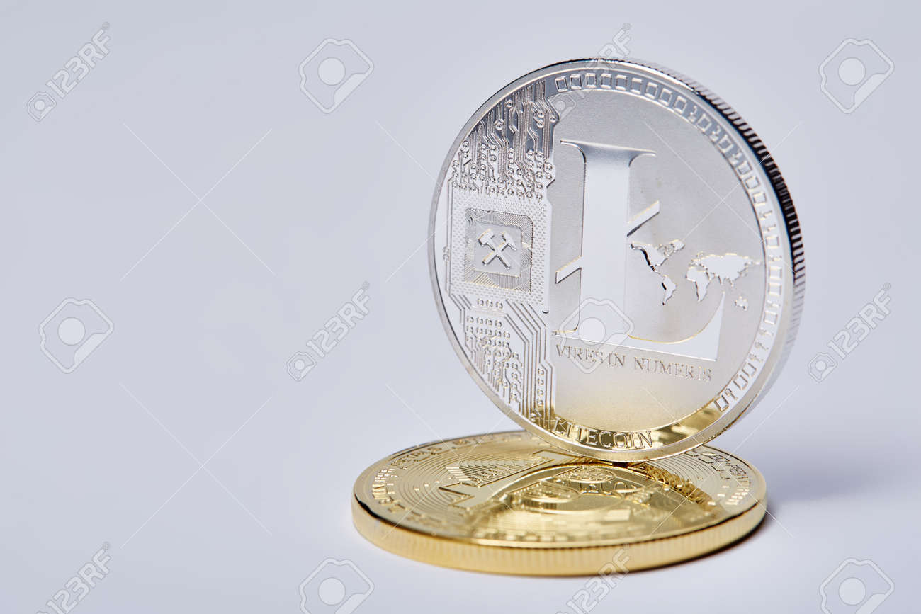 Silver Coin Of Digital Crypto Currency With The Symbol Of Litecoin And  Motto On A White Background, Close-up, Macro. Shiny Cryptocoin. Conceptual  Studio Shot. Physical Embodiment Of Virtual Digital Currency.  Cruptocurrency Concept.