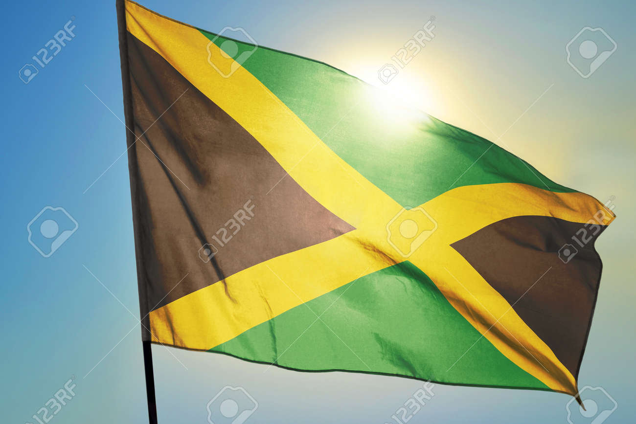 Jamaica flag waving on the wind in front of sun - 166480082 Jamaica flag waving on the wind in front of sun - 166480082