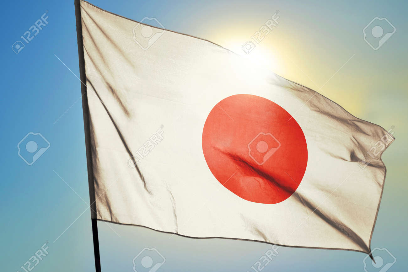 Japan flag waving on the wind in front of sun - 166480084 Japan flag waving on the wind in front of sun - 166480084