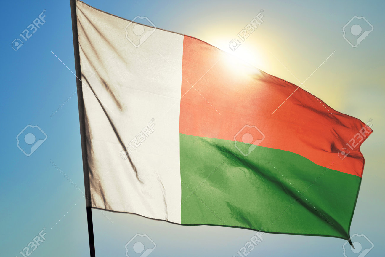Madagascar flag waving on the wind in front of sun - 166480101 Madagascar flag waving on the wind in front of sun - 166480101