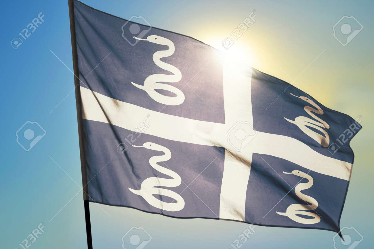 Martinique flag waving on the wind in front of sun - 166480108 Martinique flag waving on the wind in front of sun - 166480108