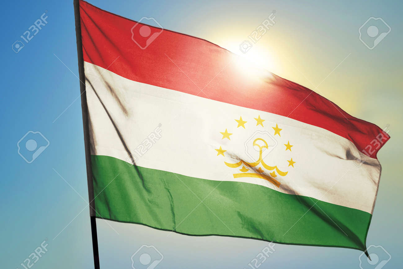 Tajikistan flag waving on the wind in front of sun - 166480152 Tajikistan flag waving on the wind in front of sun - 166480152