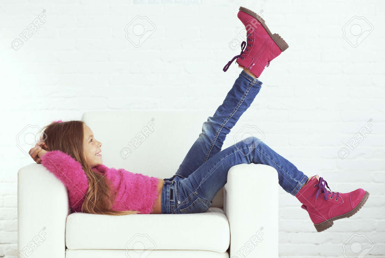 Cute Pre Teen Girl Wearing Fashion Winter Clothes Posing In White Interior Stock Photo Cute Pre Teen Girl Wearing Fashion Winter Clothes Posing In White Interior Stock Photo