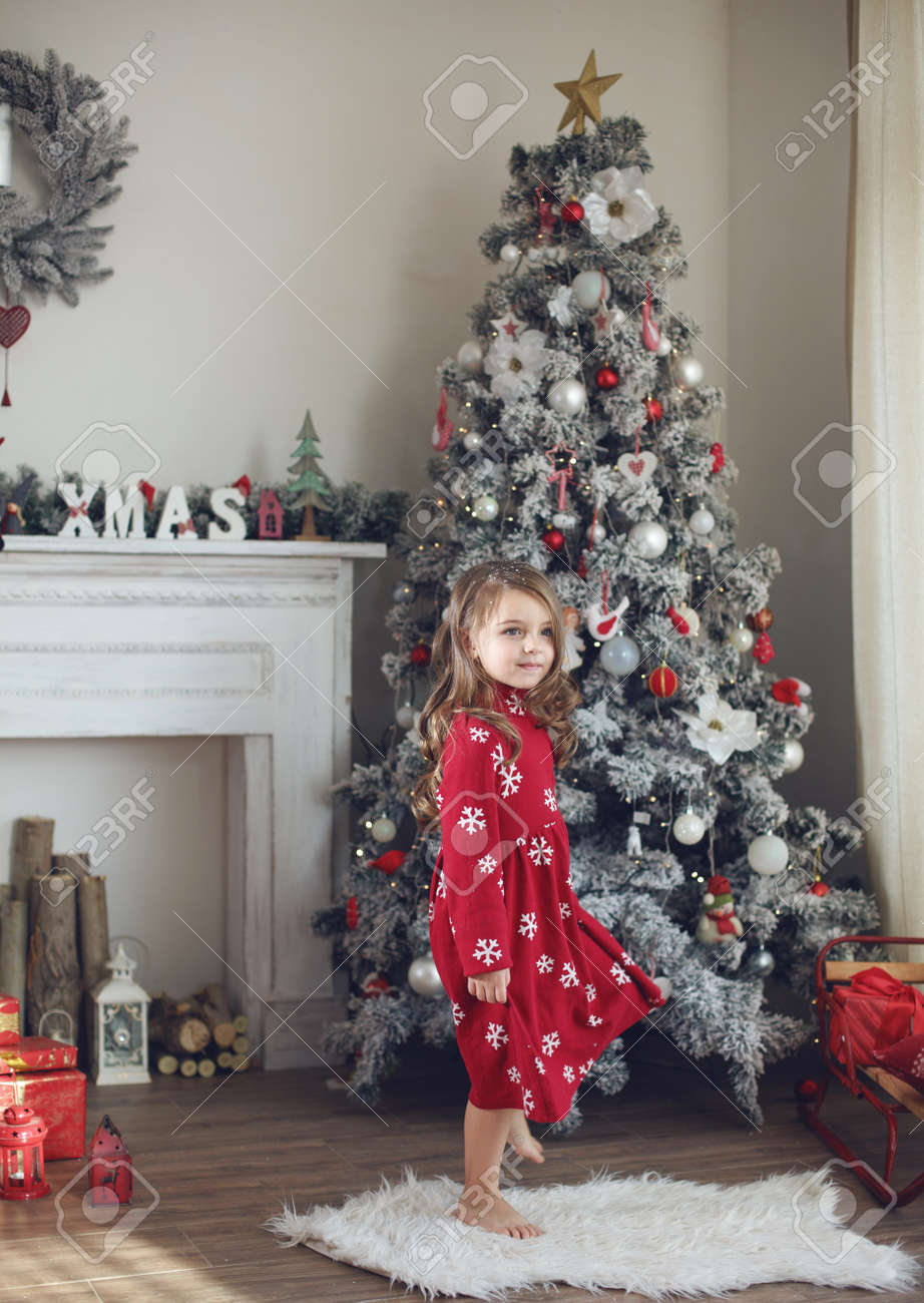 girl decorating christmas tree