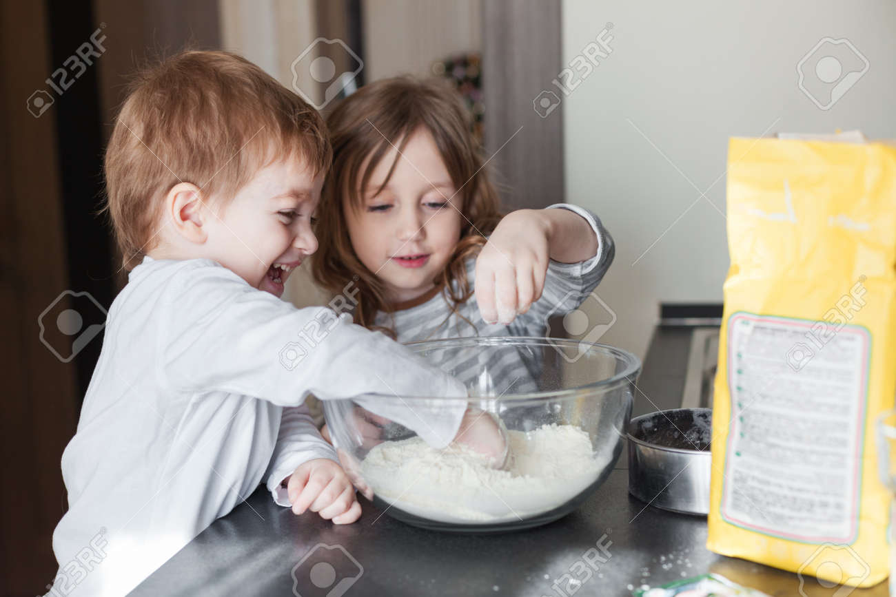 Siblings cooking holiday pie in the kitchen, casual still life photo series - 52019790 Siblings cooking holiday pie in the kitchen, casual still life photo series - 52019790
