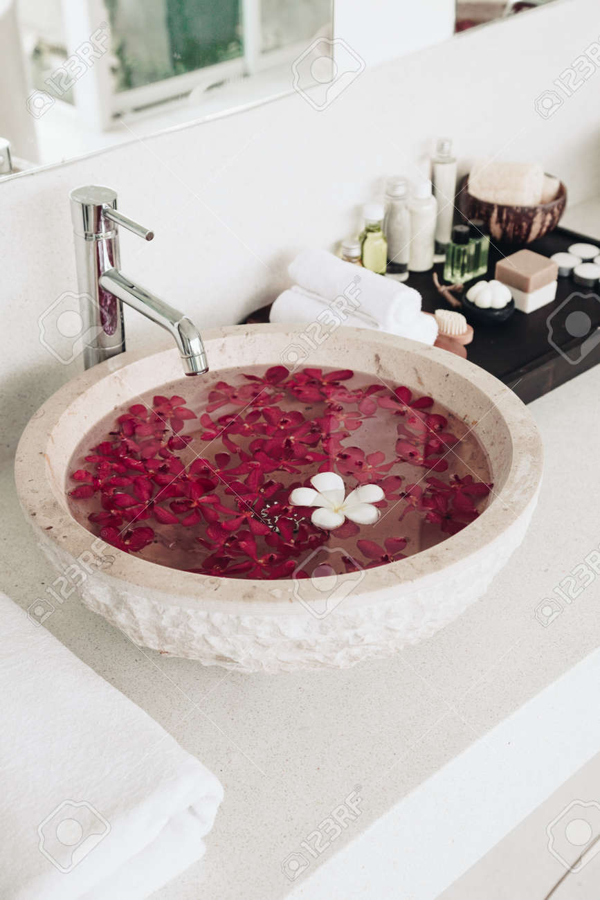 luxury hotel bathroom details sink with flowers spa decoration