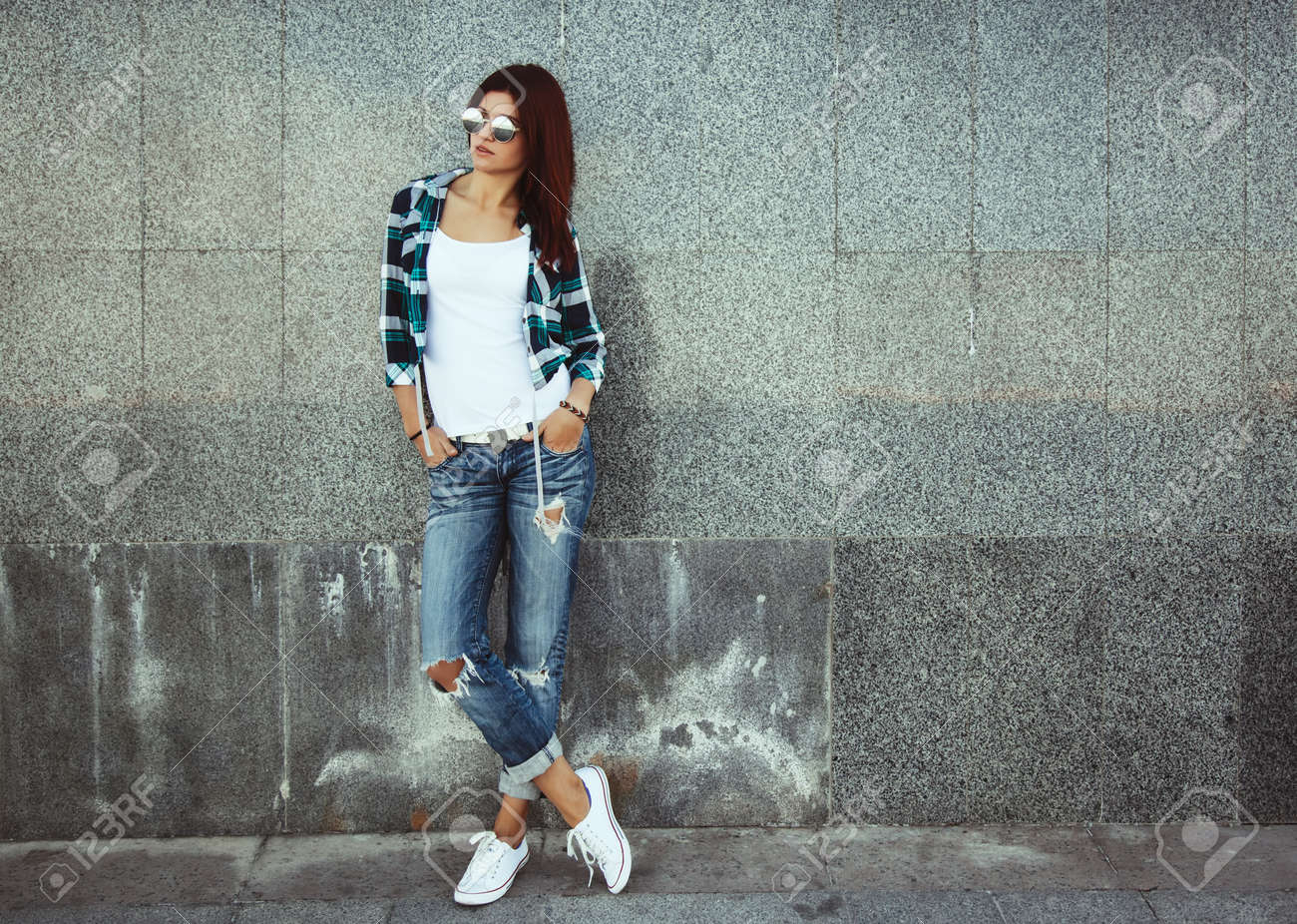 Hipster girl wearing white t,shirt, fashion sunglasses and jeans..