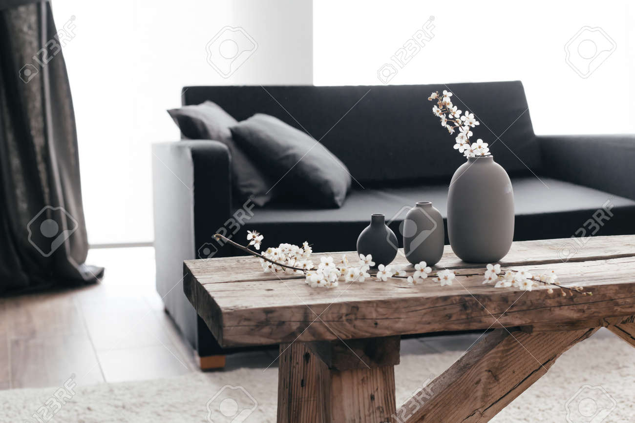 Minimalistic Home Decor On Rustic Coffee Table Over Black Sofa Minimalistic Home Decor On Rustic Coffee Table Over Black Sofa