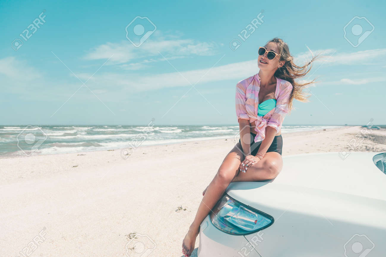 Girl Feeling Wind And Freedom While Relaxing At The Beach Car