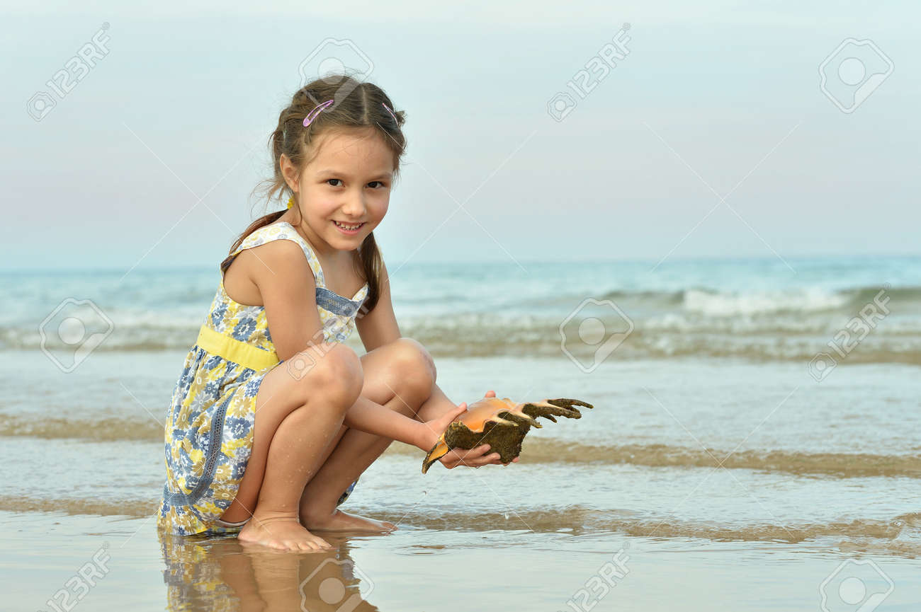 Cute Little Girl On Beach With Shell Stock Photo Picture And Royalty Free Image Image 3324 Cute Little Girl On Beach With Shell Stock Photo Picture And Royalty Free Image Image 3324