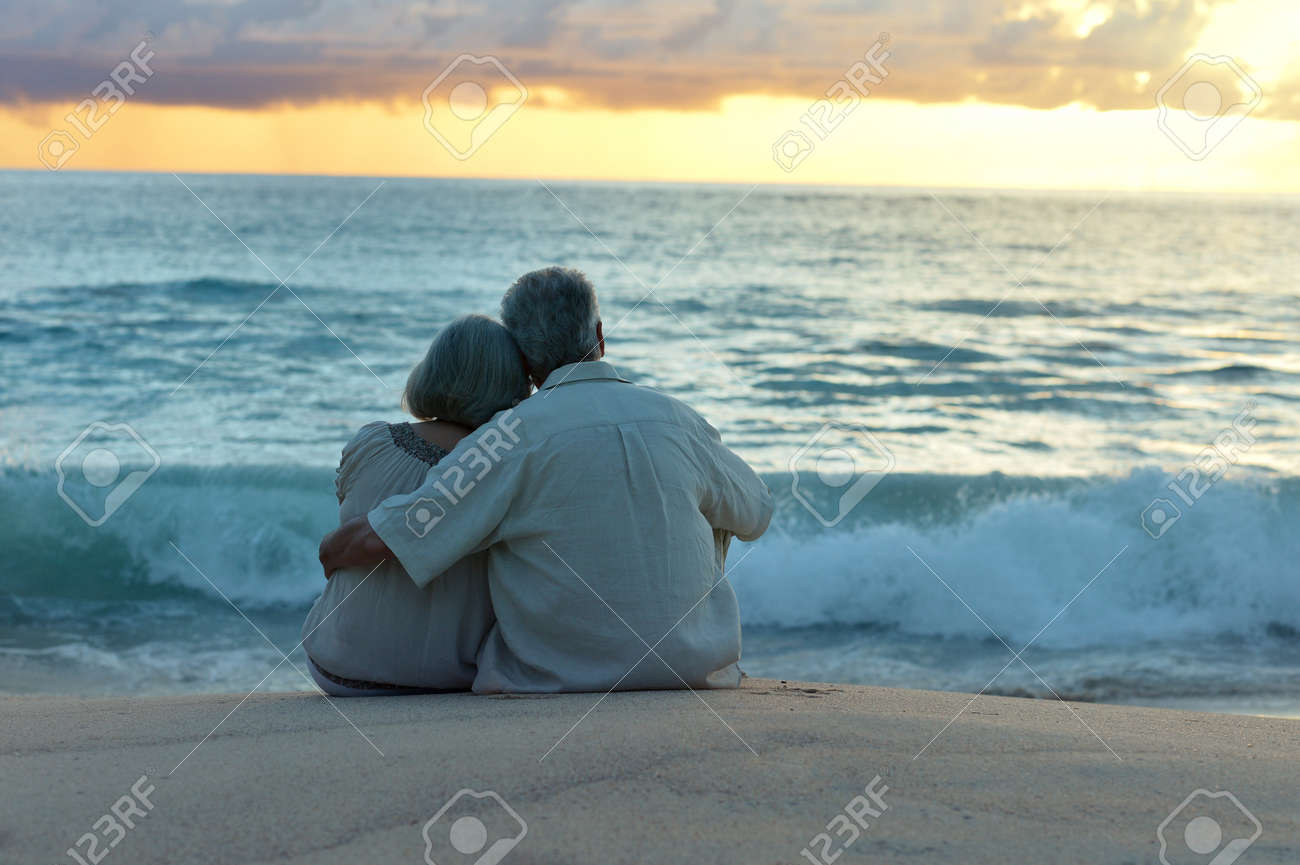 Beautiful happy elderly couple rest at tropical resort,back view - 47315789 Beautiful happy elderly couple rest at tropical resort,back view - 47315789