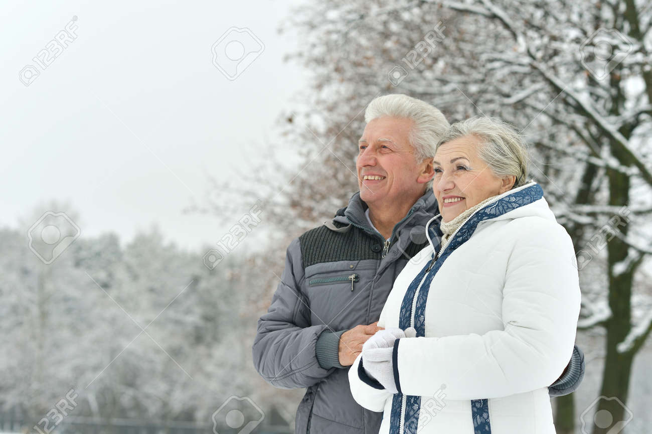 Portrait of elderly couple having fun outdoors in winter forest - 47639616 Portrait of elderly couple having fun outdoors in winter forest - 47639616