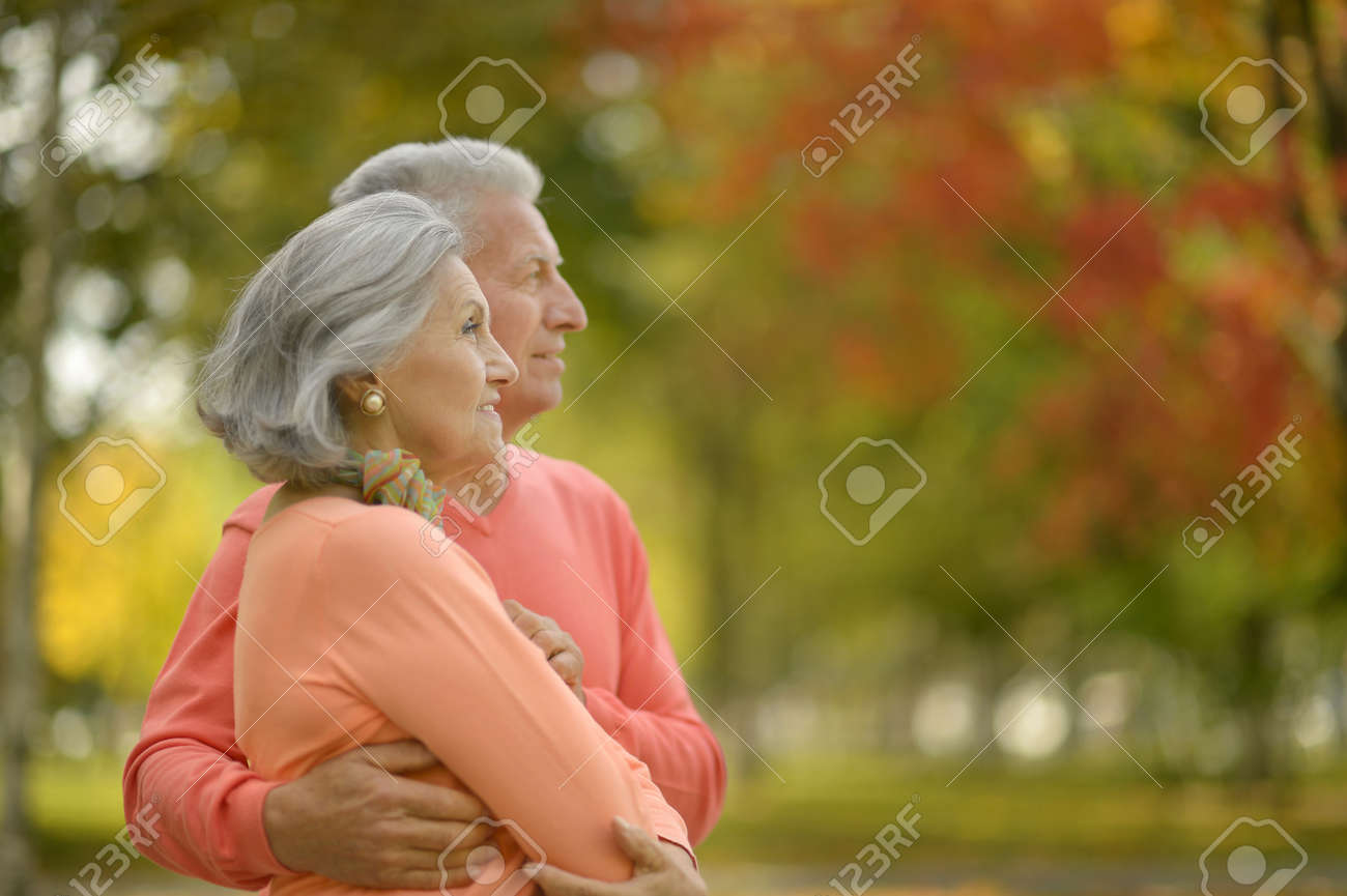 Beautiful caucasian elderly couple in the park in autumn - 48347273 Beautiful caucasian elderly couple in the park in autumn - 48347273