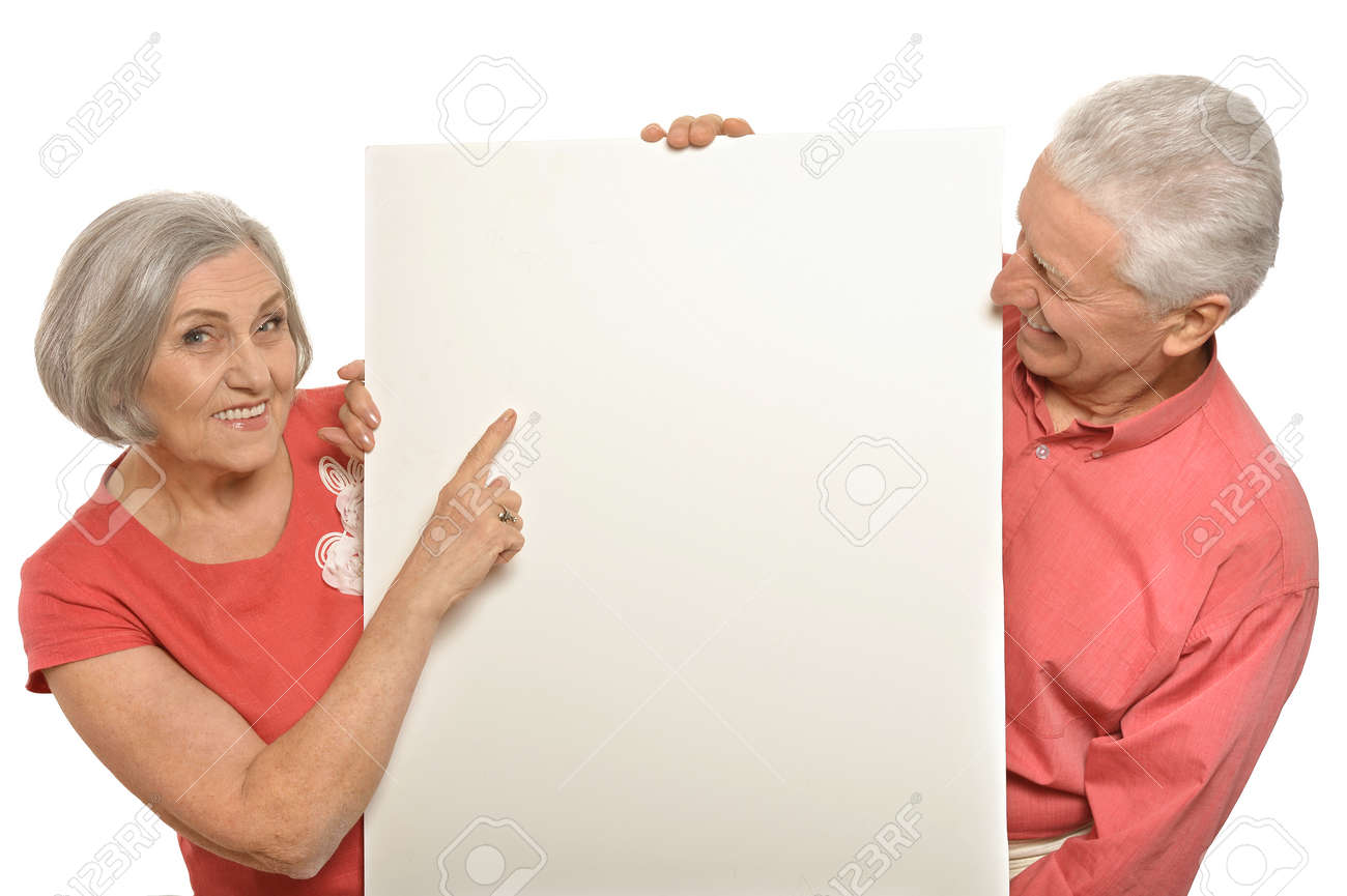 Two elderly posing with board on white - 49190292 Two elderly posing with board on white - 49190292