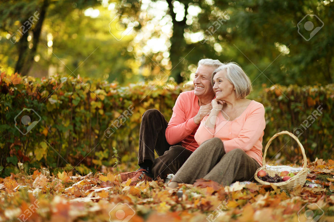 Beautiful caucasian elderly couple in the park in autumn - 52625014 Beautiful caucasian elderly couple in the park in autumn - 52625014