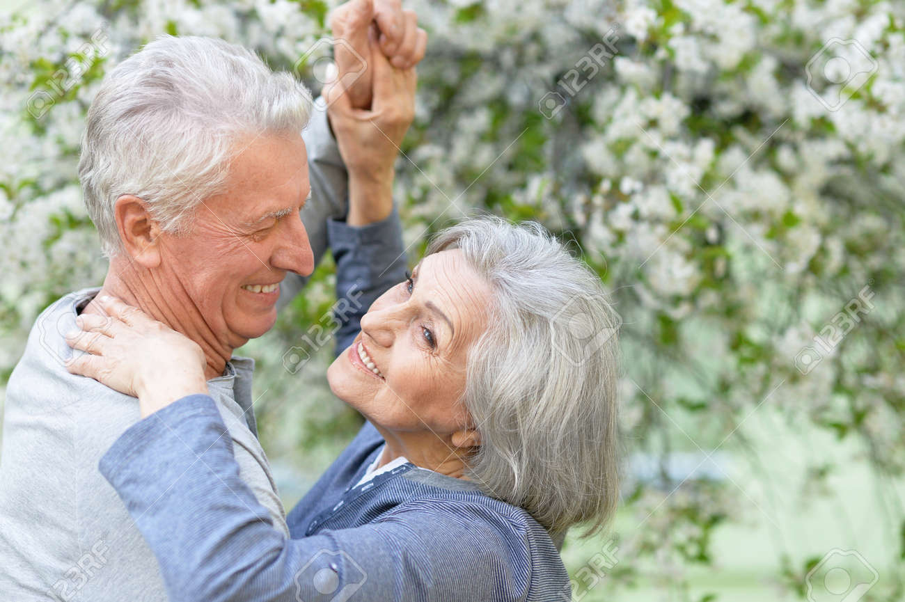 Nice Mature couple dancing in spring park - 58680578 Nice Mature couple dancing in spring park - 58680578