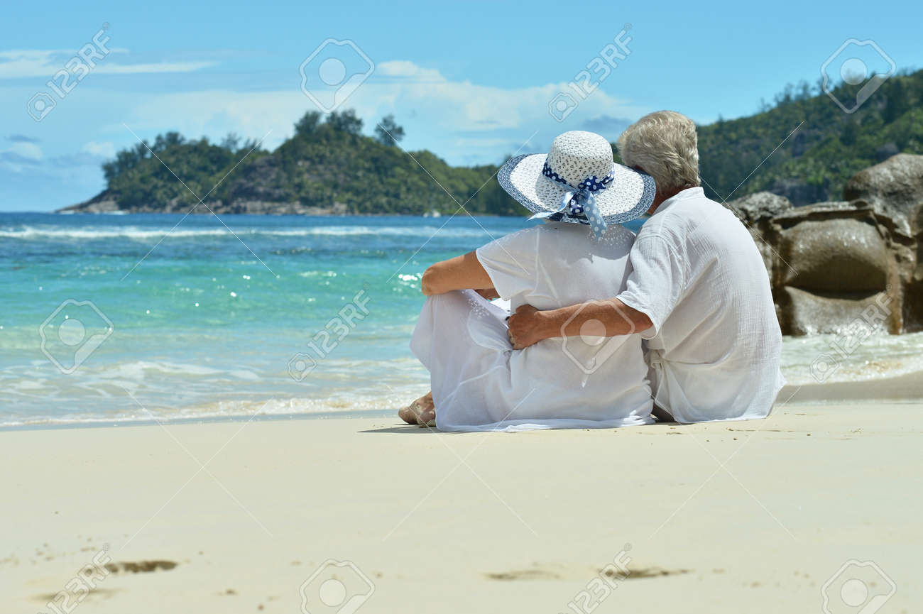 Portrait of a senior couple resting on beach - 80914793 Portrait of a senior couple resting on beach - 80914793