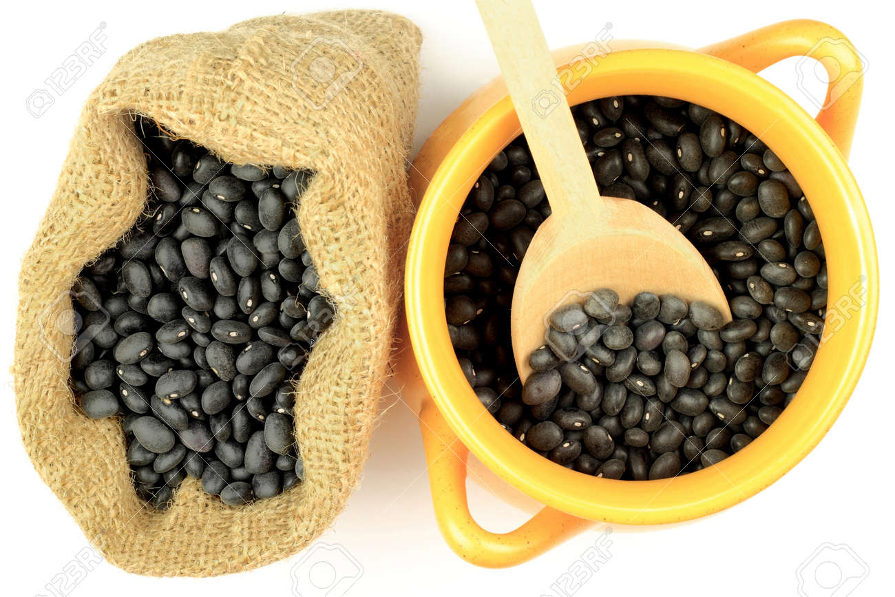 Black Beans Seeds In Orange Pottery Bowl Wooden Cooking Spoon And Burlap Bag Over White Black Beans Seeds In Orange Pottery Bowl Wooden Cooking Spoon And Burlap Bag Over White