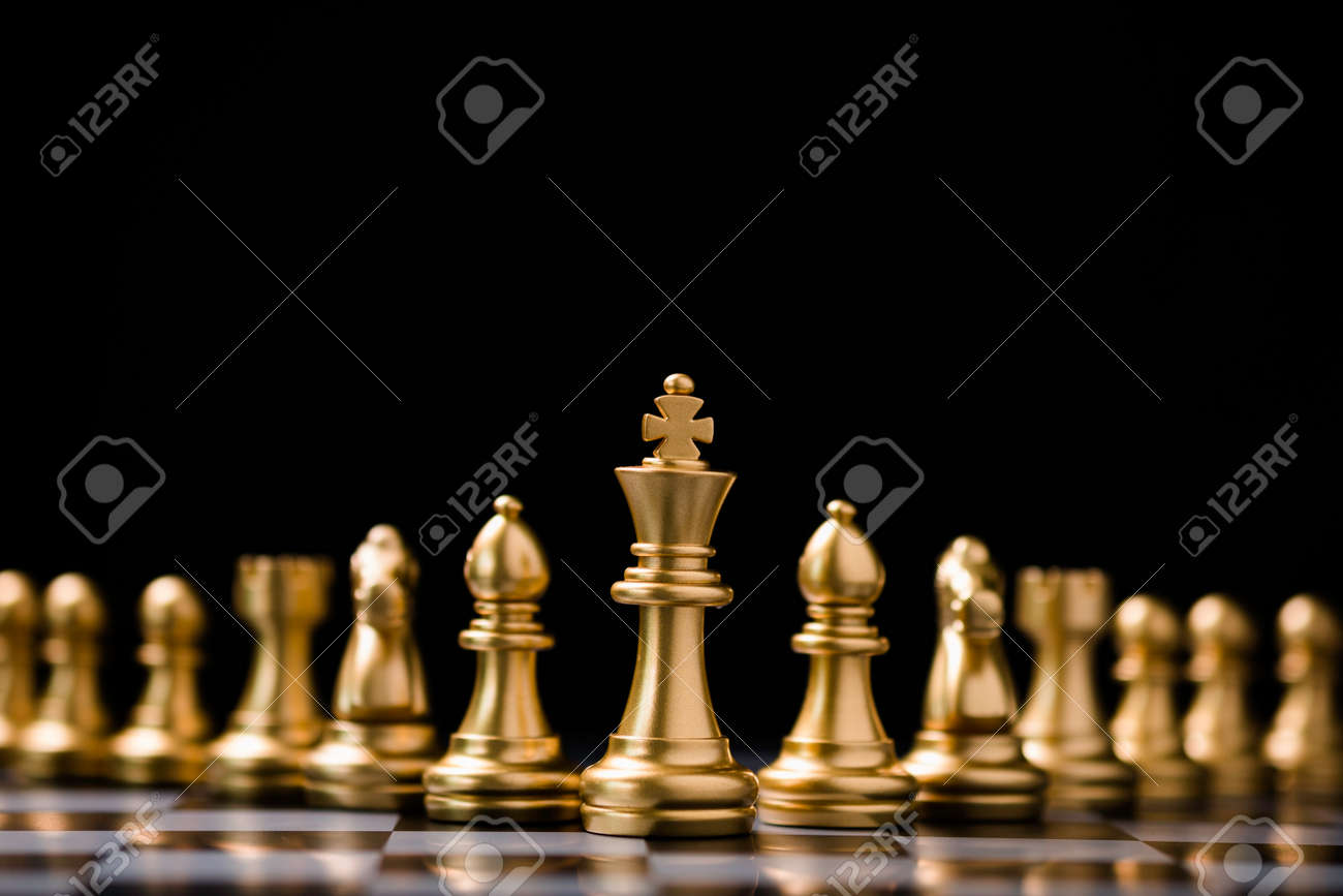 Golden Chess King In Front Of A Checkered Board Stock Photo